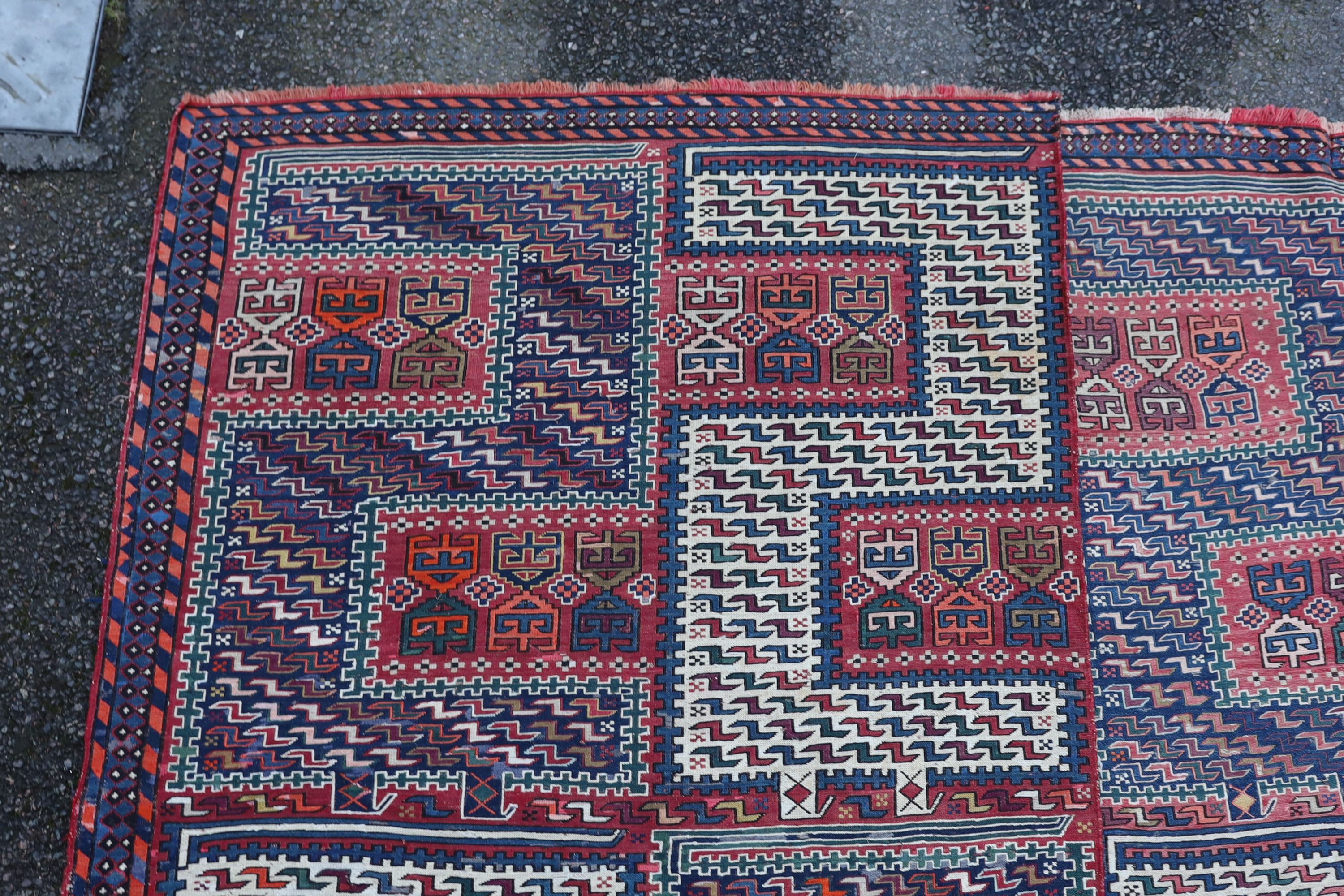 A Sumak weave 2-sectional carpet, combined dimension - 320 x 230cm.